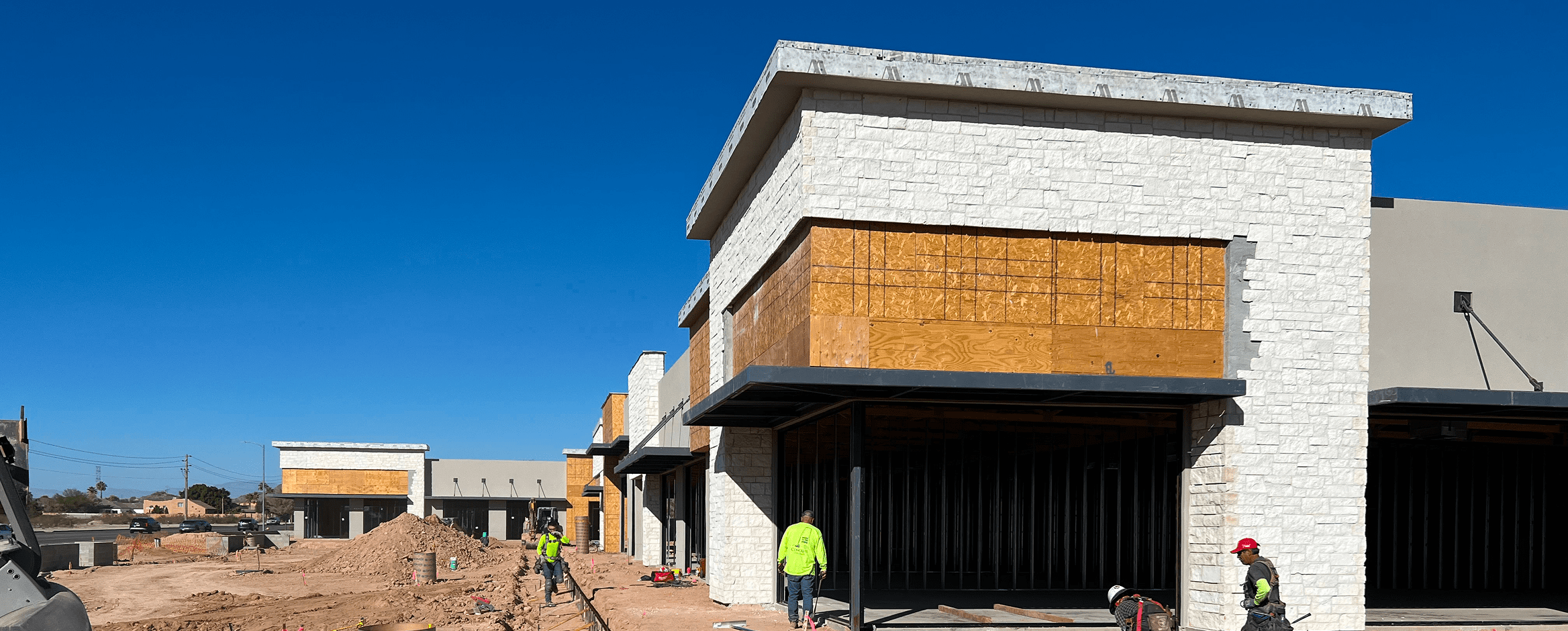 Construction site with workers and buildings