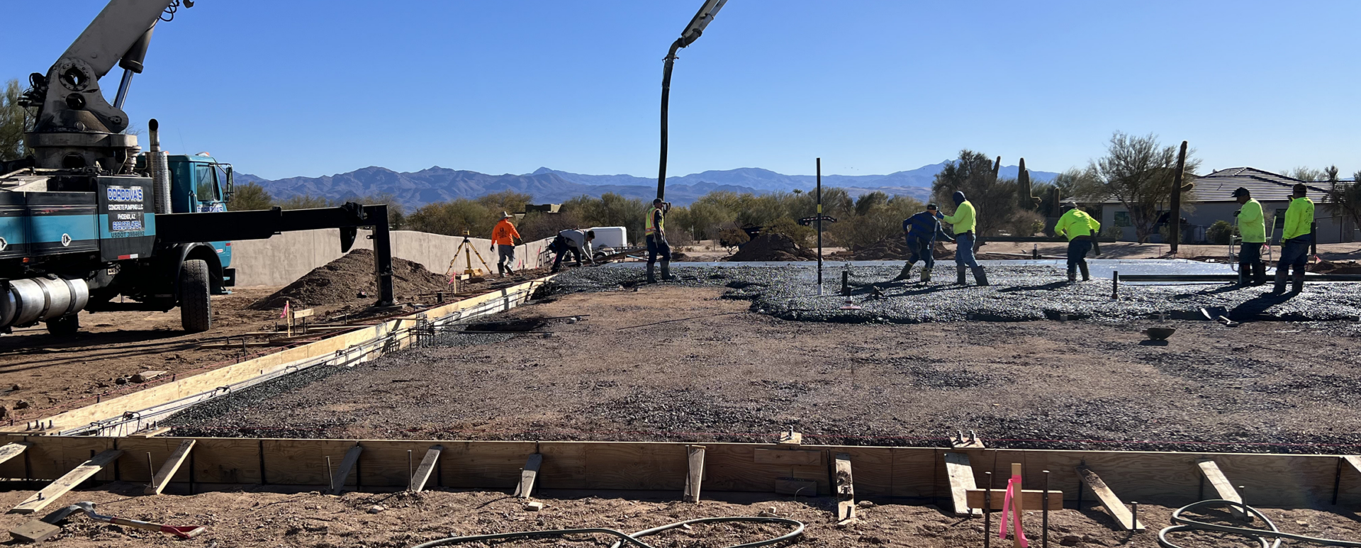 Workers using machinery on construction site
