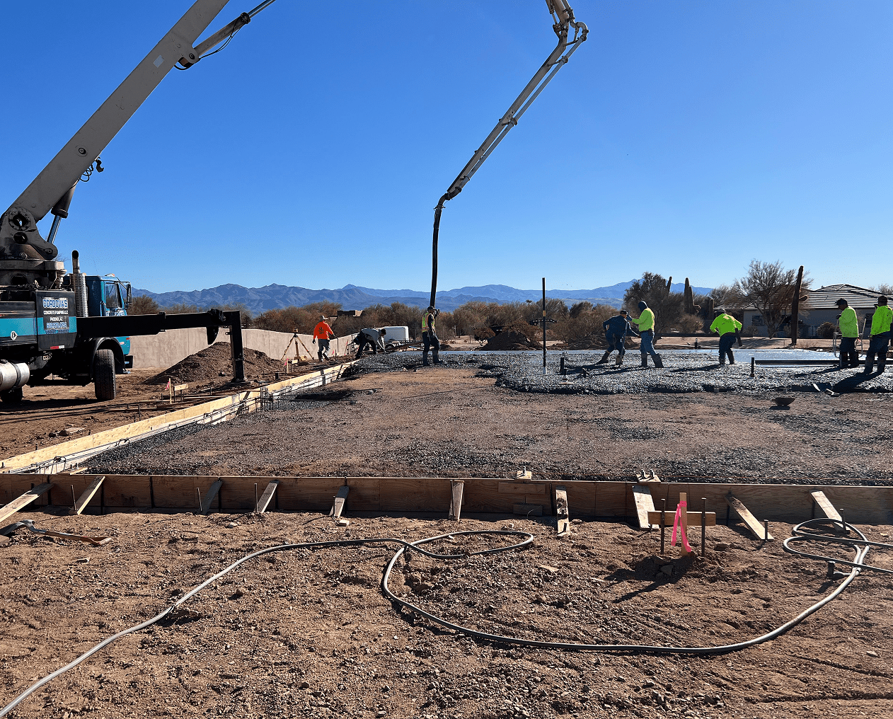 Construction workers pouring concrete on site